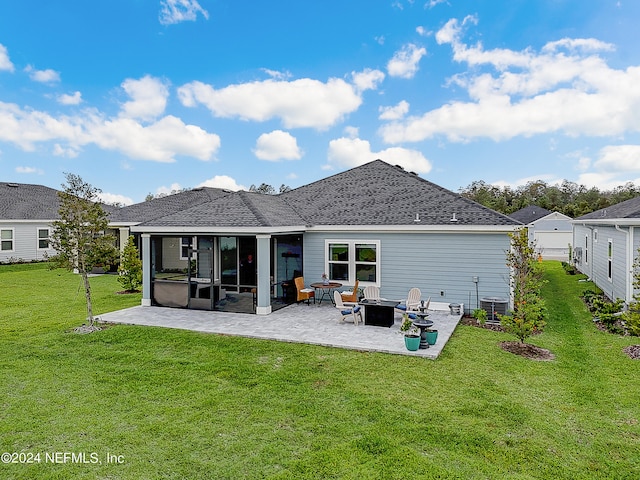 rear view of house with a yard and a patio