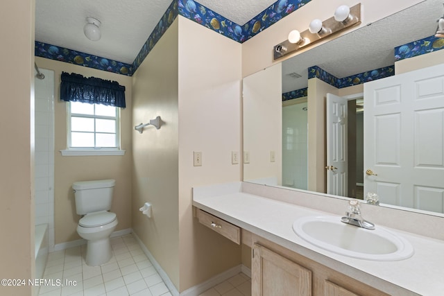 bathroom featuring vanity, toilet, tile patterned floors, and a textured ceiling