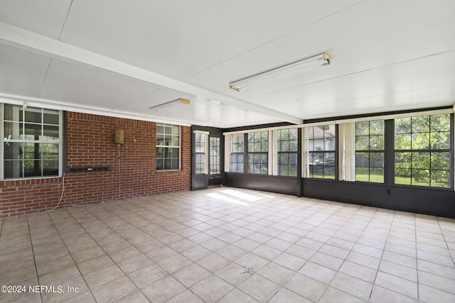 unfurnished sunroom featuring a wealth of natural light