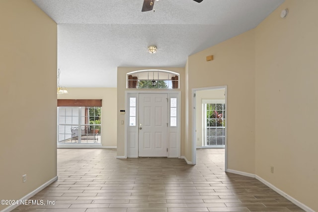 foyer with ceiling fan, hardwood / wood-style flooring, and a textured ceiling