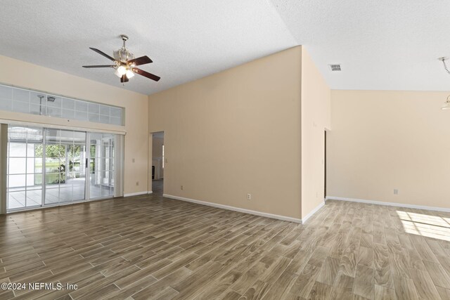 unfurnished living room featuring a textured ceiling, high vaulted ceiling, wood-type flooring, and ceiling fan