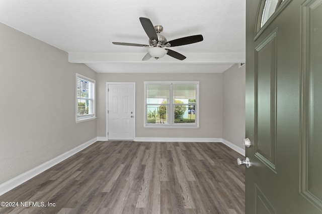 unfurnished room with beam ceiling, wood-type flooring, and ceiling fan