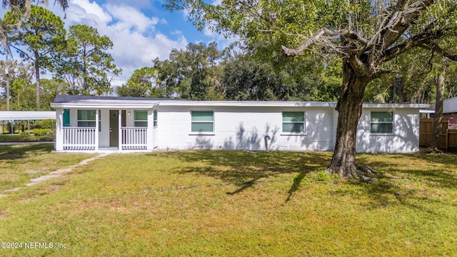 ranch-style house with covered porch and a front lawn