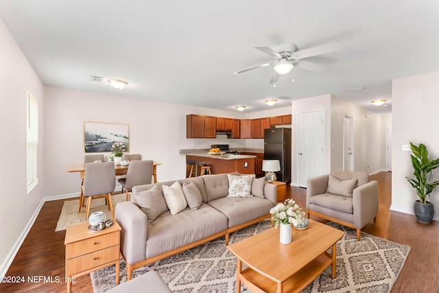 living room featuring dark hardwood / wood-style floors and ceiling fan