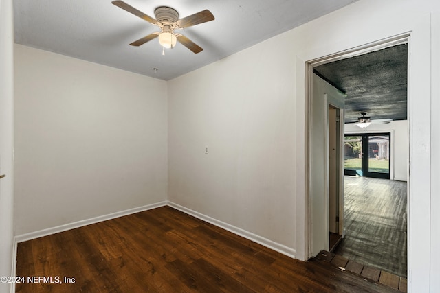 unfurnished room featuring dark hardwood / wood-style floors and ceiling fan