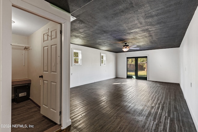 unfurnished room with a textured ceiling, dark hardwood / wood-style floors, and ceiling fan