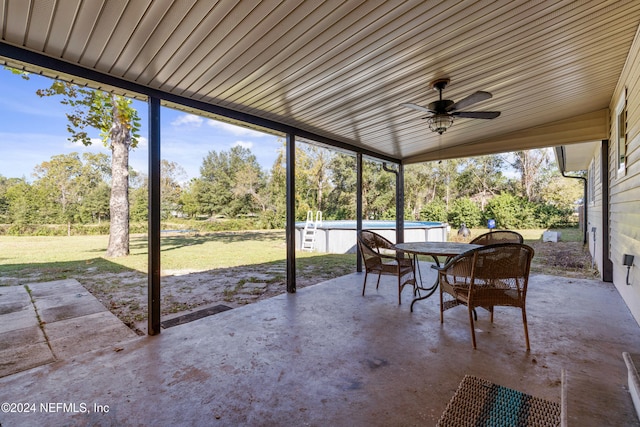 unfurnished sunroom with vaulted ceiling and ceiling fan