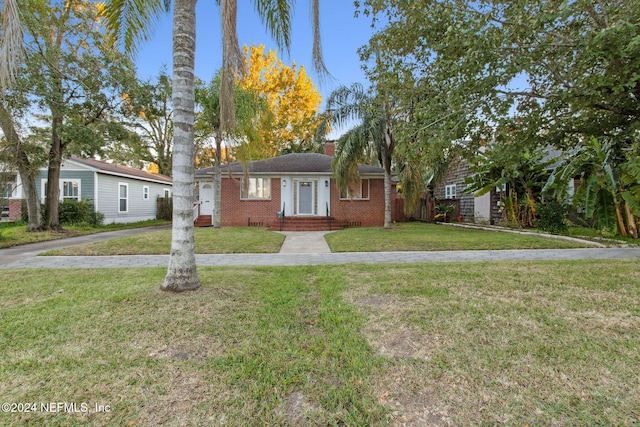 ranch-style home with a front lawn