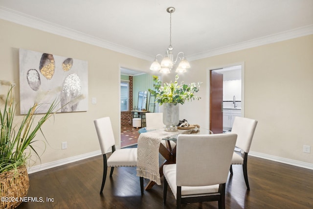 dining room featuring crown molding, a notable chandelier, sink, and dark hardwood / wood-style floors