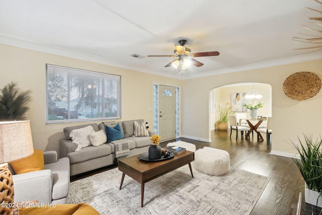 living room with ornamental molding, wood-type flooring, and ceiling fan