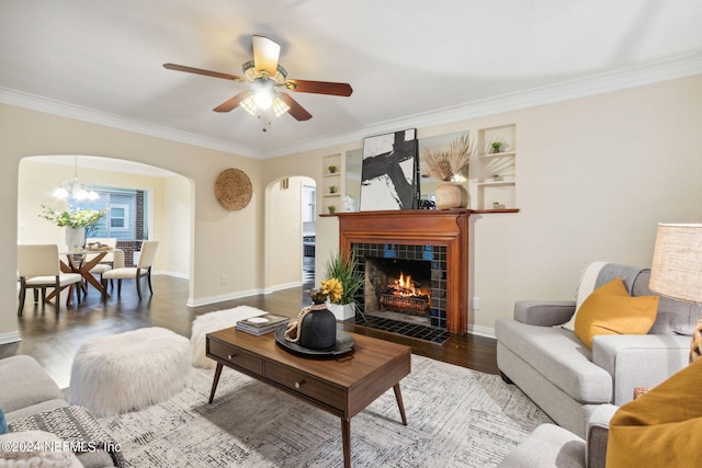 living room featuring ornamental molding, hardwood / wood-style floors, and a tile fireplace