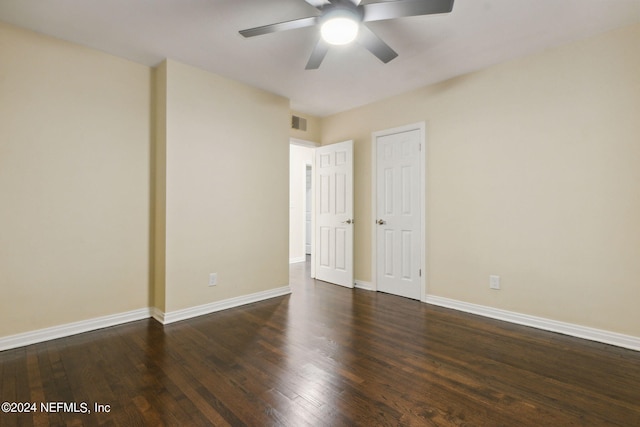 unfurnished room with ceiling fan and dark hardwood / wood-style floors