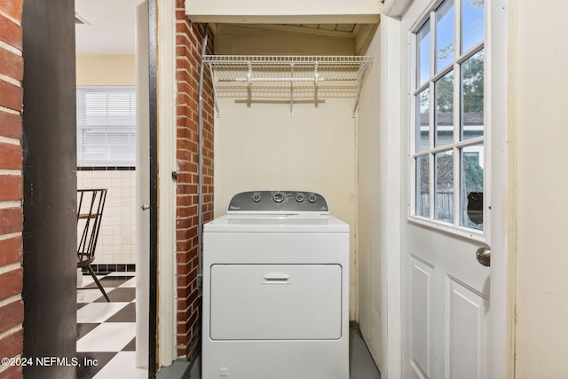 laundry area featuring washer / clothes dryer and tile walls