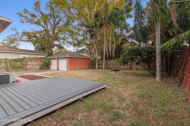 view of yard featuring a deck and central AC unit