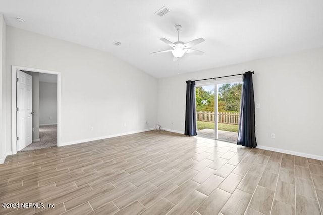 empty room with ceiling fan, lofted ceiling, and light wood-type flooring