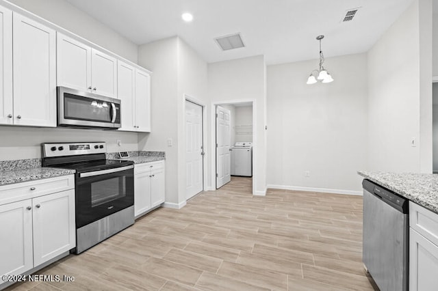 kitchen featuring appliances with stainless steel finishes, hanging light fixtures, white cabinetry, light hardwood / wood-style floors, and light stone counters