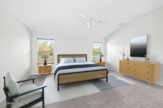 carpeted bedroom featuring ceiling fan, lofted ceiling, and multiple windows