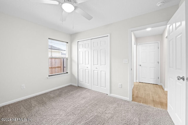 unfurnished bedroom with a closet, light colored carpet, and ceiling fan