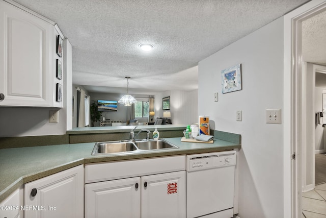 kitchen with light tile patterned floors, white cabinetry, a textured ceiling, dishwasher, and sink