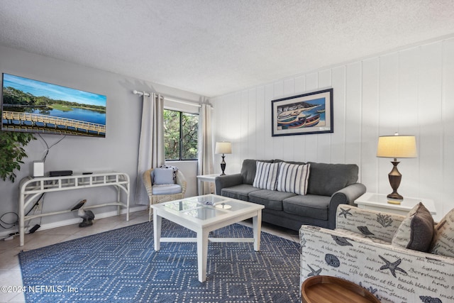 tiled living room featuring a textured ceiling