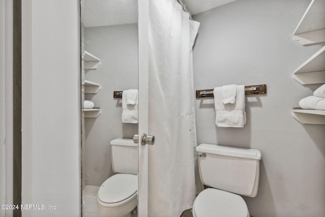 bathroom with toilet and walk in shower