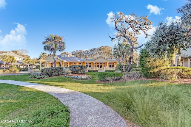 view of front of home with covered porch and a front yard