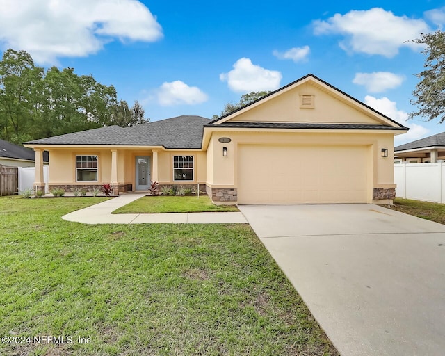 view of front of home with a front yard and a garage