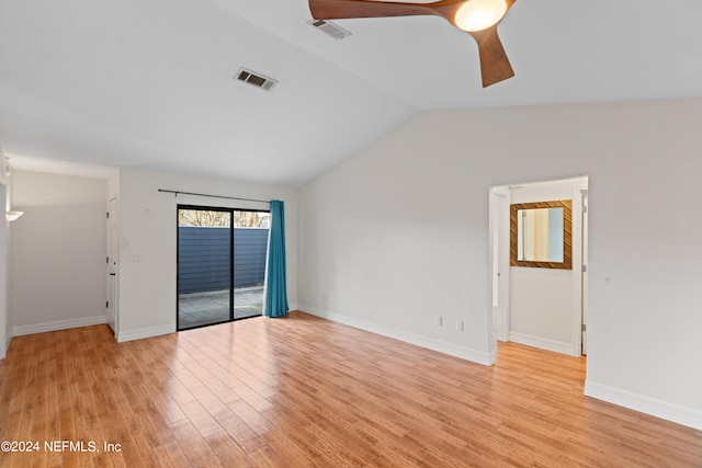 spare room featuring visible vents, light wood-type flooring, and lofted ceiling