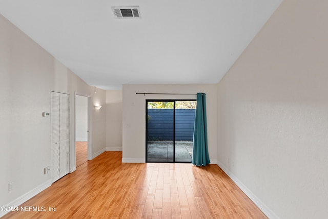 unfurnished room with visible vents, baseboards, and light wood-style flooring