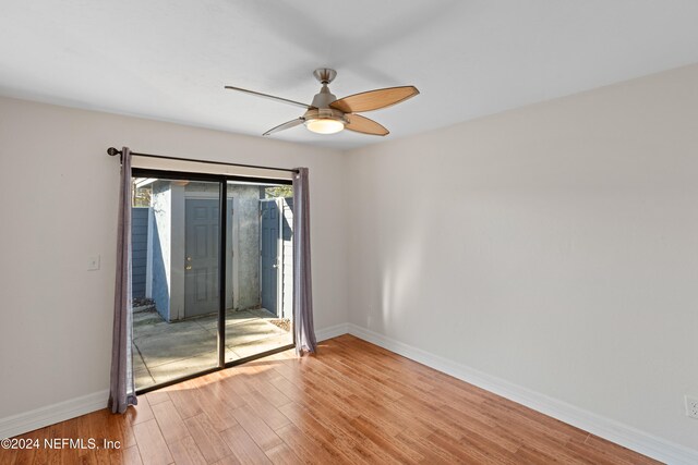 empty room with a ceiling fan, baseboards, and light wood finished floors