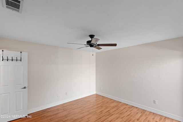 spare room featuring visible vents, ceiling fan, baseboards, and light wood-style floors