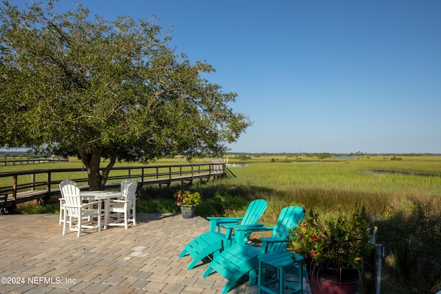 view of patio / terrace with outdoor dining area and a rural view