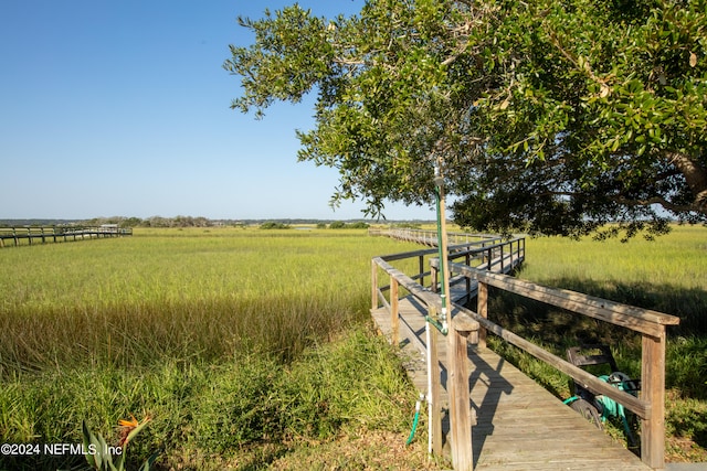 view of dock with a rural view