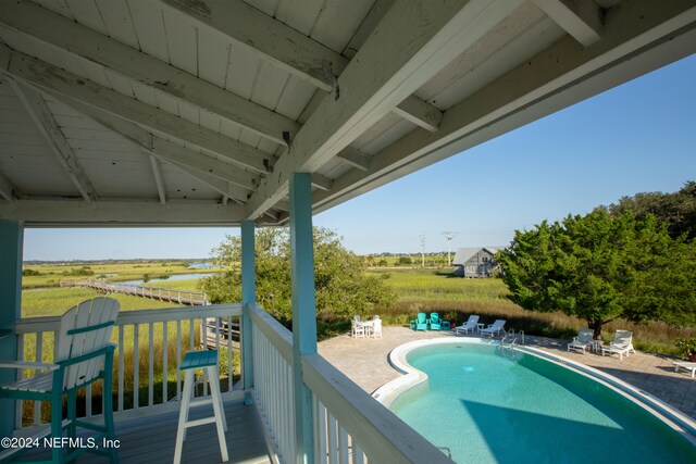 exterior space featuring a fenced in pool and a patio