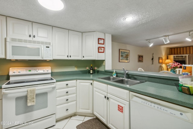 kitchen with sink, rail lighting, white cabinetry, a textured ceiling, and white appliances