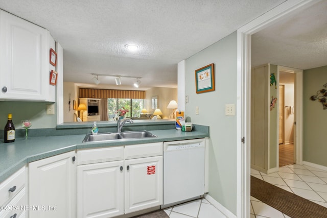 kitchen with sink, dishwasher, white cabinets, and a textured ceiling