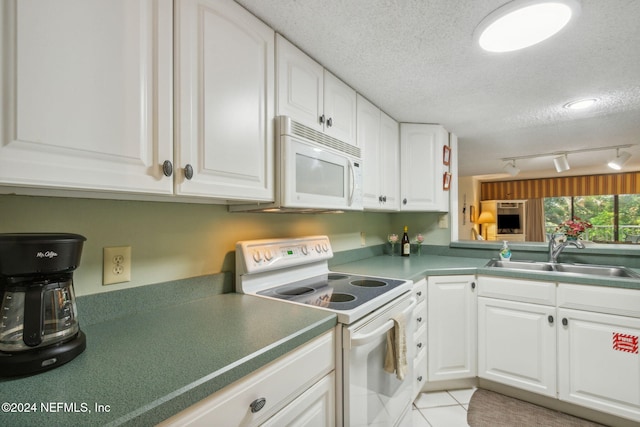 kitchen with sink, white cabinetry, a textured ceiling, and white appliances