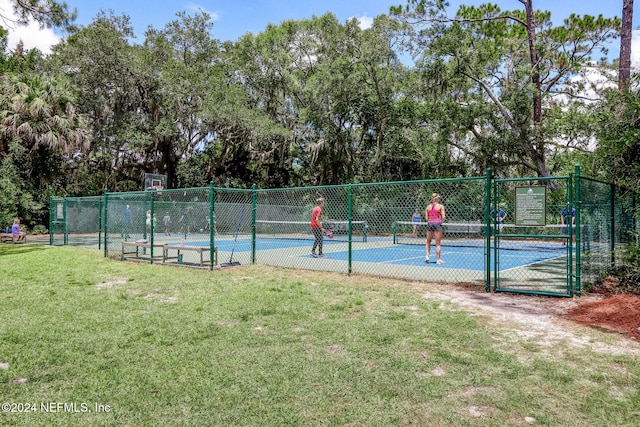 view of tennis court with a yard and basketball court