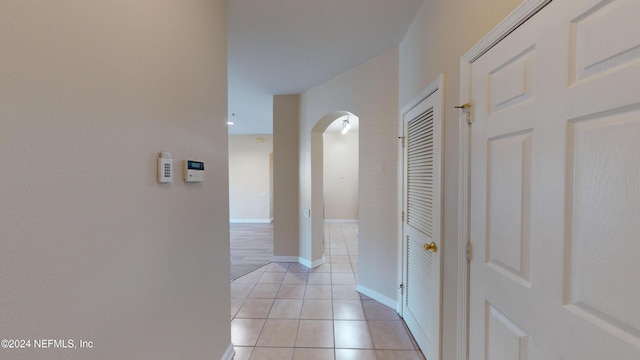 corridor featuring light tile patterned flooring