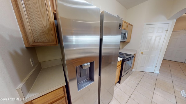 kitchen with stainless steel appliances and light tile patterned floors