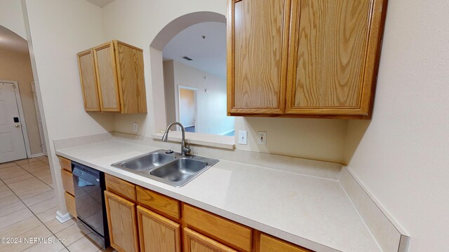 7990 Baymeadows Rd E Unit 410, Jacksonville, FL 32256 - kitchen with dishwasher, a sink, light tile patterned floors, light countertops, and arched walkways