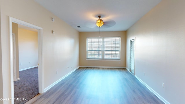 empty room featuring hardwood / wood-style floors and ceiling fan