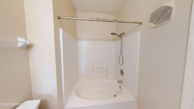 bathroom featuring washtub / shower combination and toilet