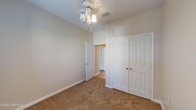 7990 Baymeadows Rd E Unit 410, Jacksonville, FL 32256 - unfurnished bedroom featuring carpet, a closet, baseboards, and a ceiling fan