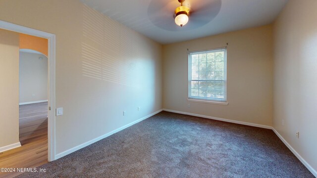 7990 Baymeadows Rd E Unit 410, Jacksonville, FL 32256 - empty room featuring arched walkways, carpet floors, and a ceiling fan