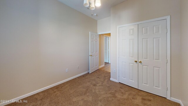 7990 Baymeadows Rd E Unit 410, Jacksonville, FL 32256 - unfurnished bedroom featuring carpet floors, baseboards, and a closet