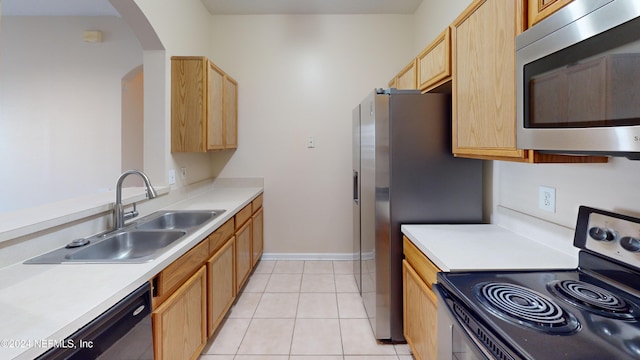 kitchen featuring sink, light brown cabinetry, appliances with stainless steel finishes, and light tile patterned floors