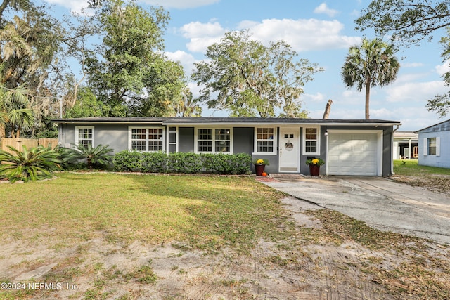 single story home featuring a front lawn and a garage