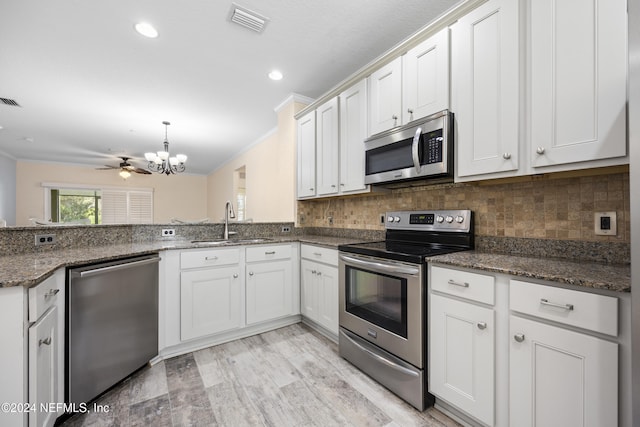 kitchen with white cabinetry, crown molding, stainless steel appliances, and sink