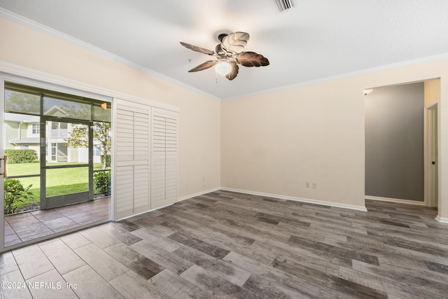 unfurnished room with hardwood / wood-style floors, crown molding, and ceiling fan